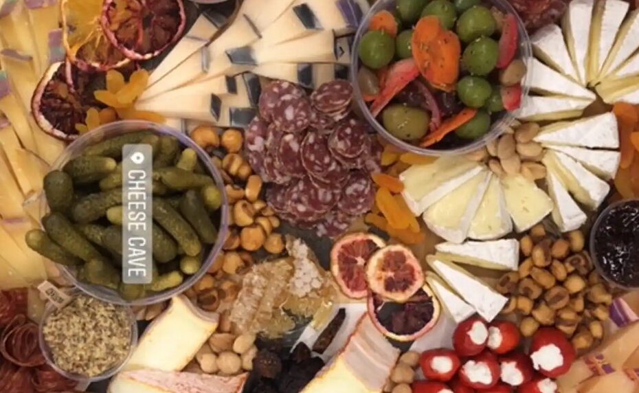 a platter of cheese that has been artfully cut and arranged
